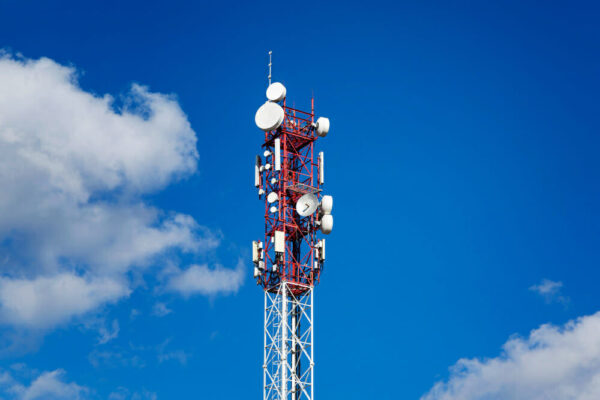 tower-5g-against-background-clear-blue-sky-among-clouds-high-technologies-tv-industry-background-space-text